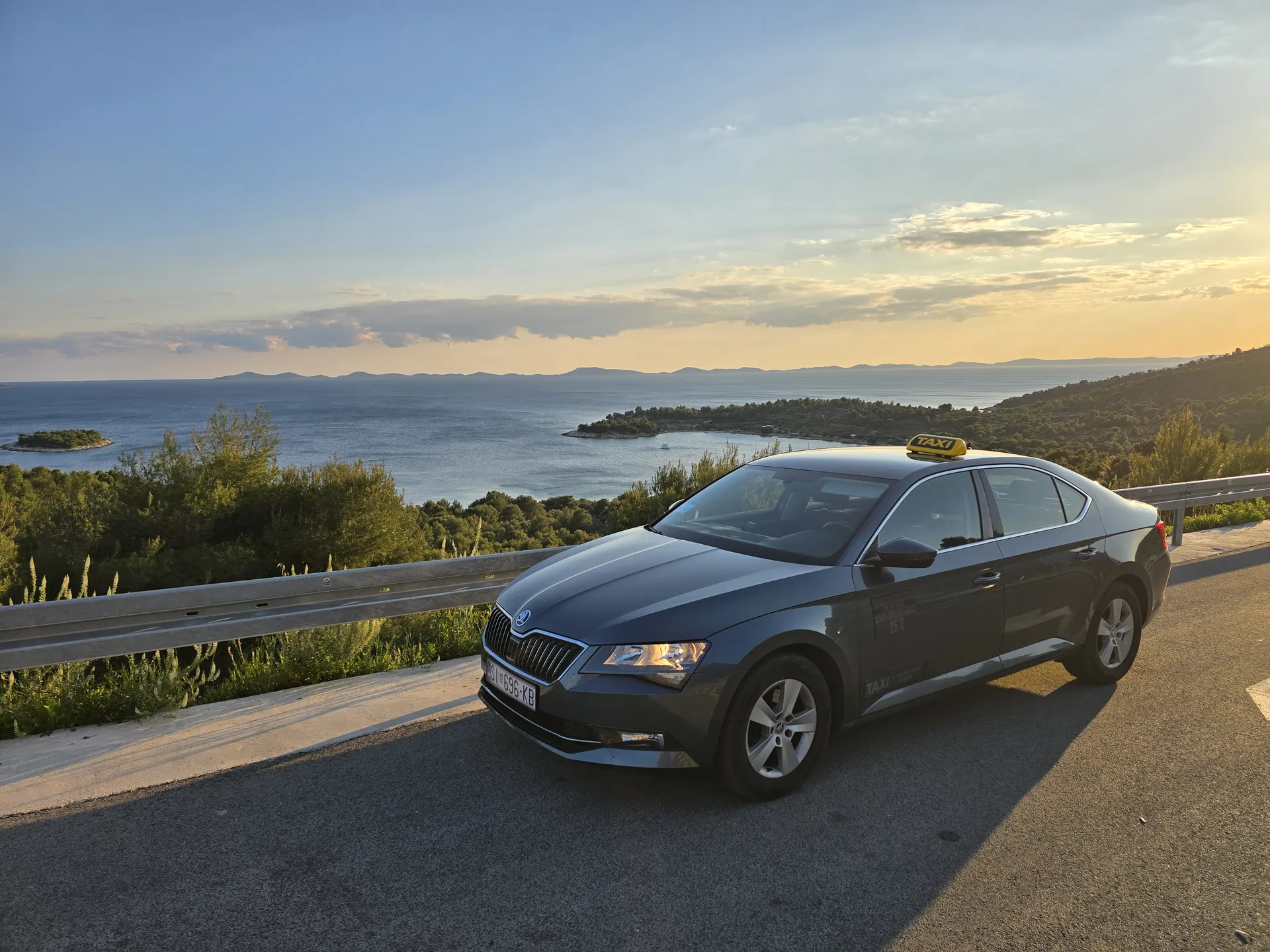 TAXI Antonio's Škoda Superb on a Dalmatian coast road near Šibenik at sunset