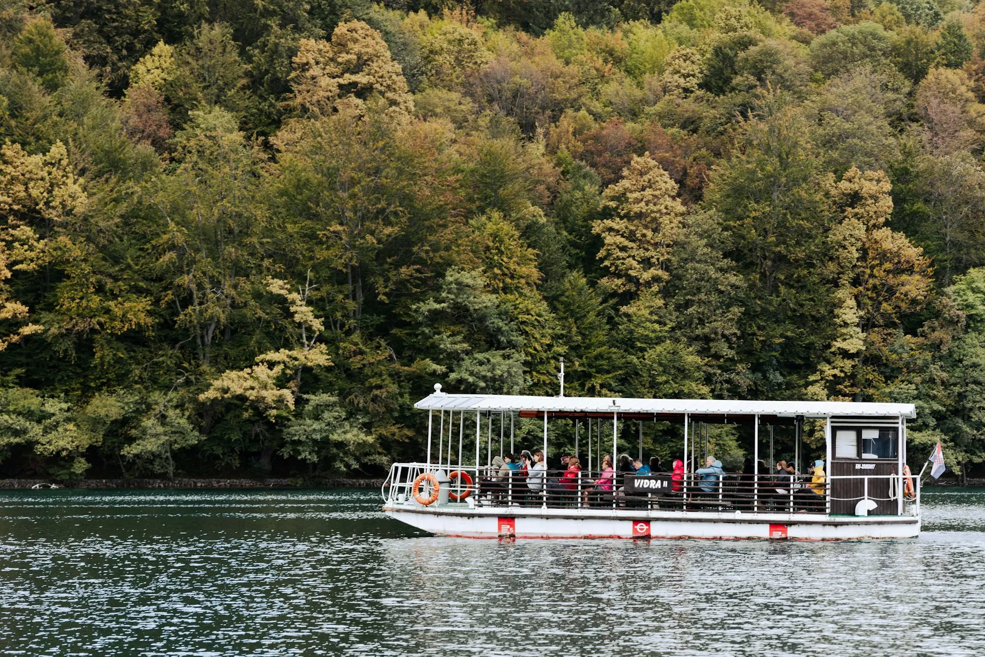 Electric boat crossing a Plitvice lake on a private transfer from Split